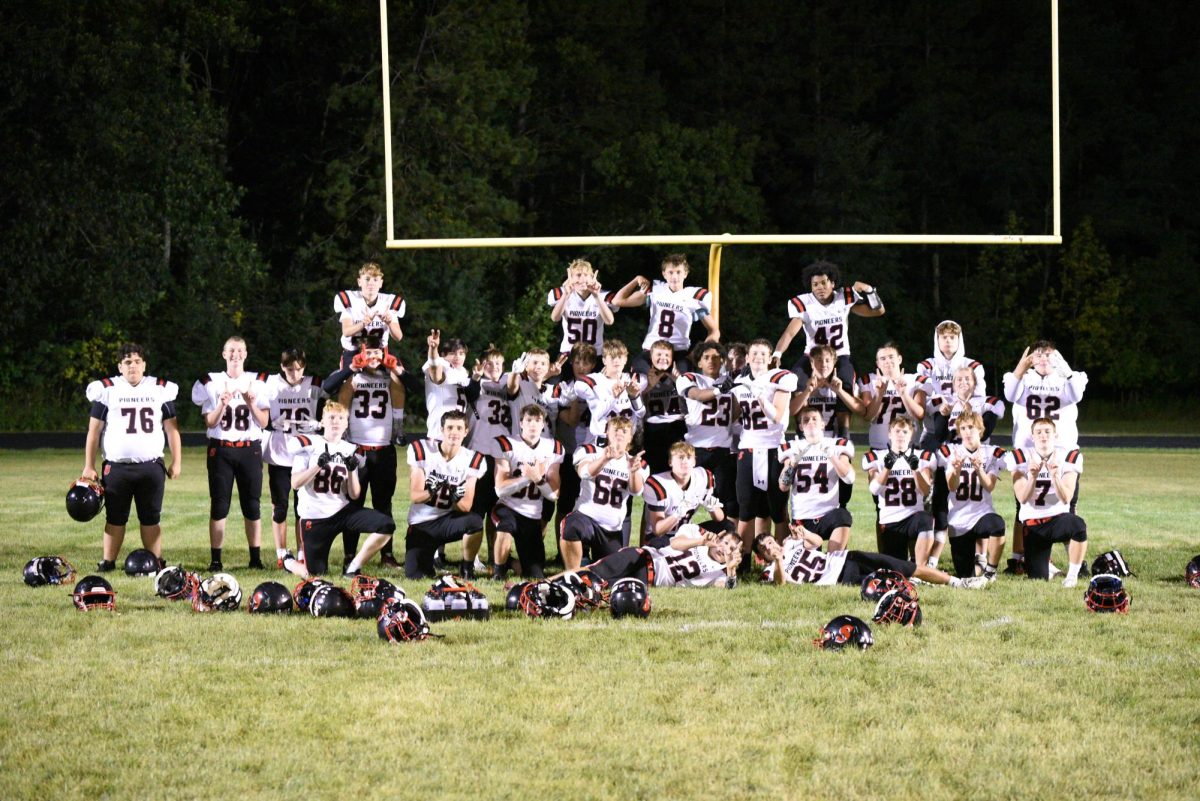 Pioneer football team poses after a big win against Wild Rose. 