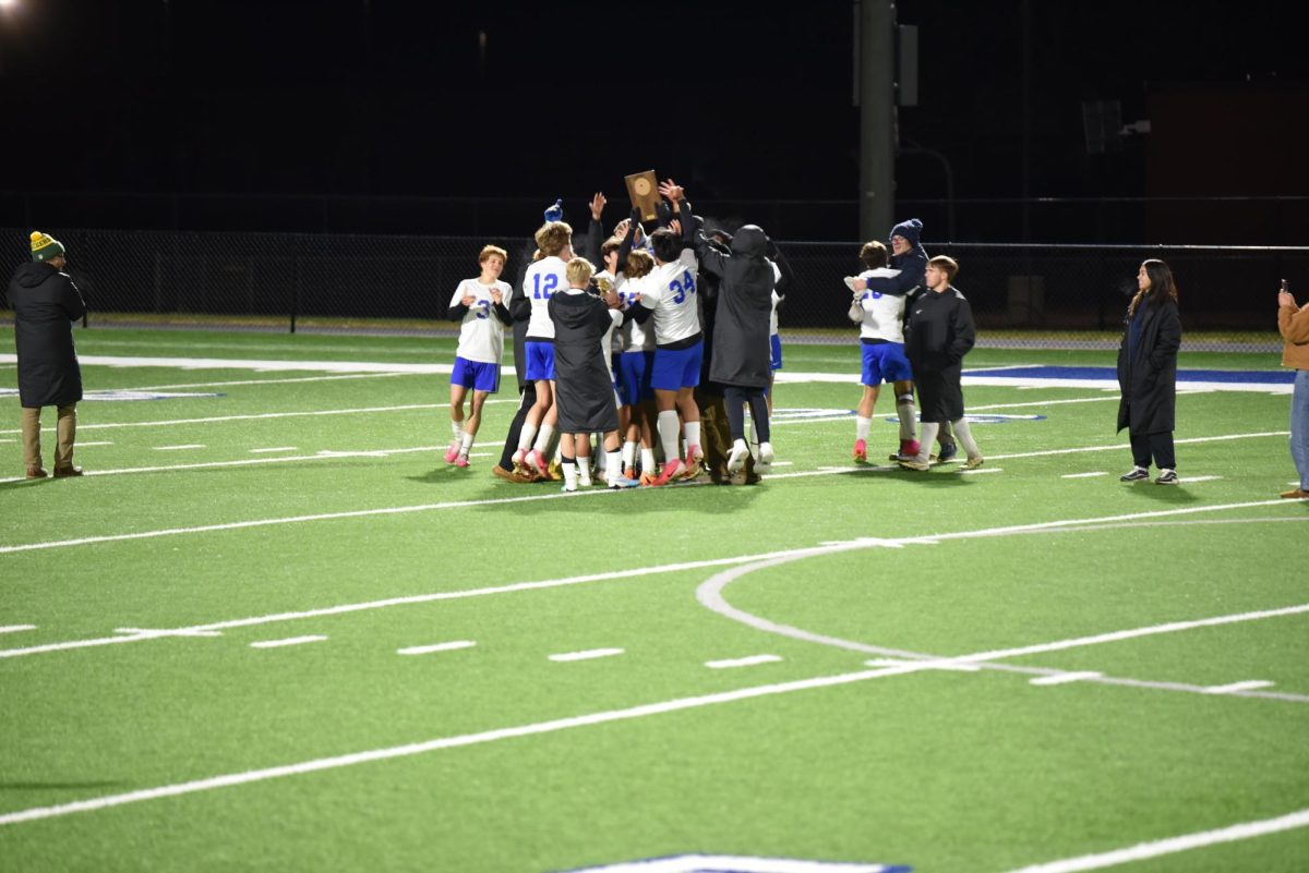 The team celebrates with their trophy